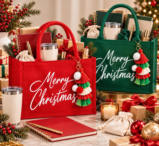 two festive gift bags, each containing various holiday-themed items such as candles, books, and ornaments, arranged on a table with a Christmas tree in the background.